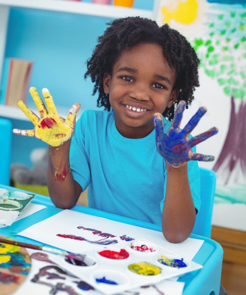happy-kid-enjoying-painting-with-his-hands